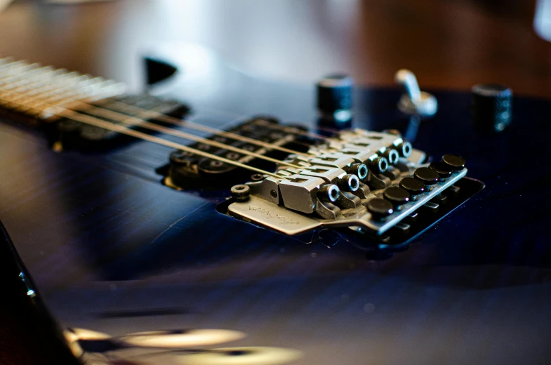 a small guitar neck is displayed on a black table