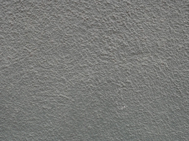 closeup of a stucco texture wall with white paint