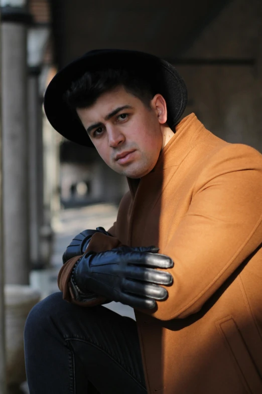 man in hat and gloves posing for a picture