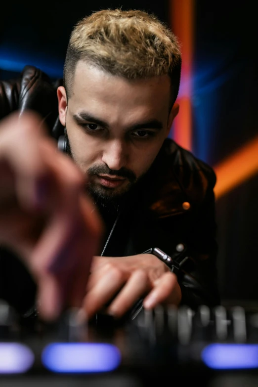 man wearing a leather jacket operating his keyboard