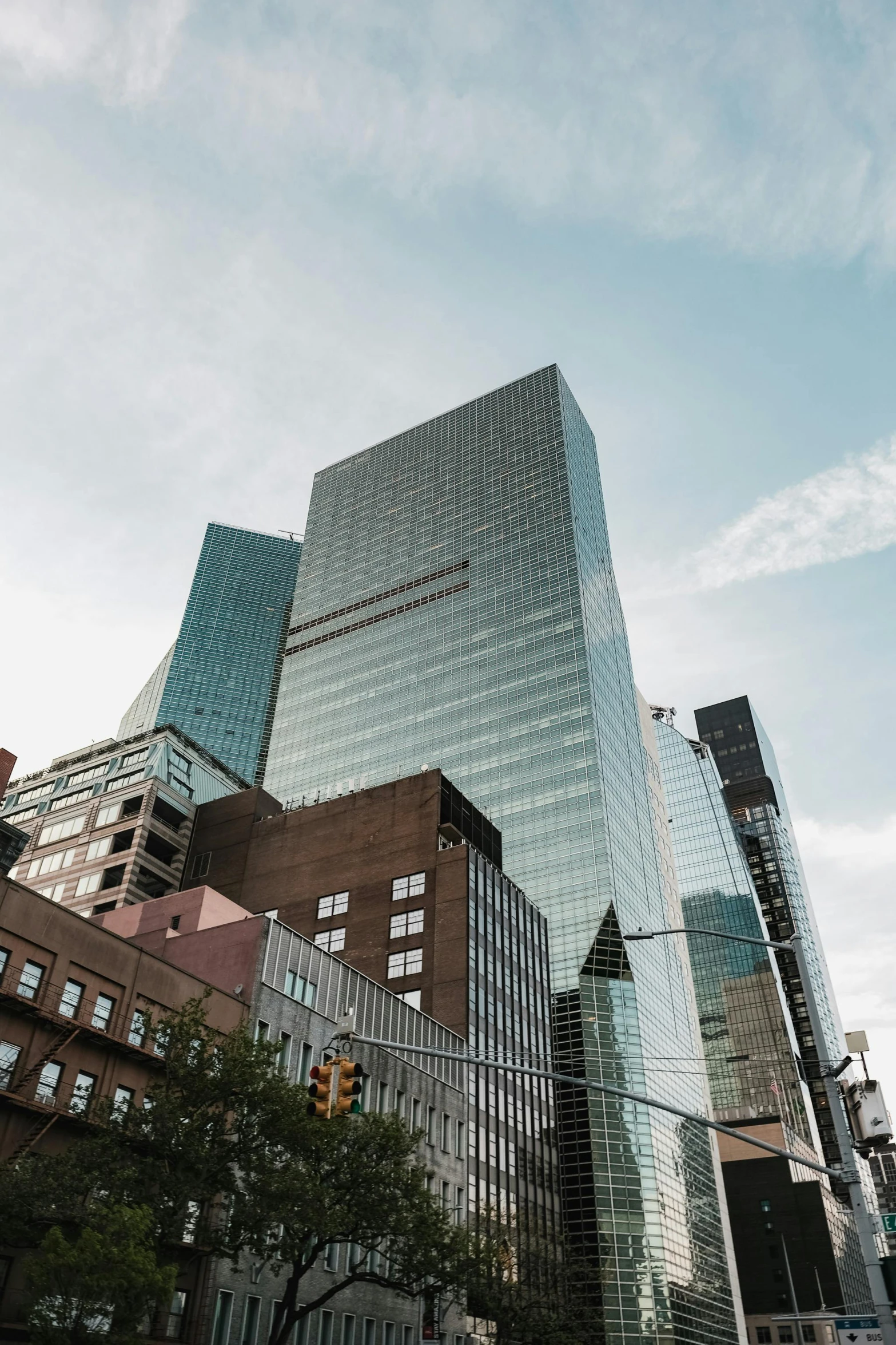 very tall buildings and trees line a wide street