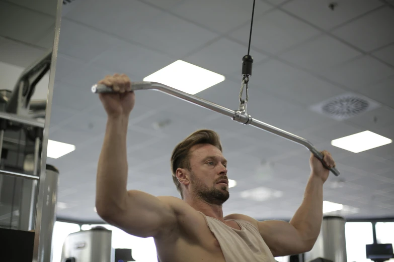 a man lifting a weight bar in a gym