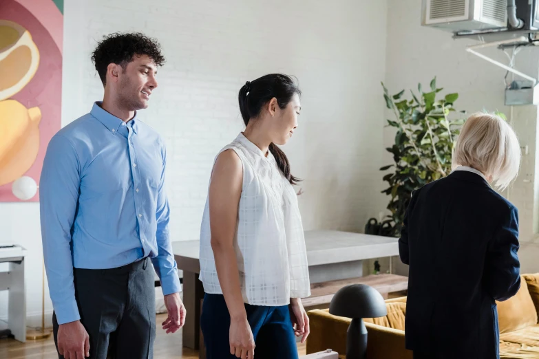 a man and woman standing next to each other in a living room