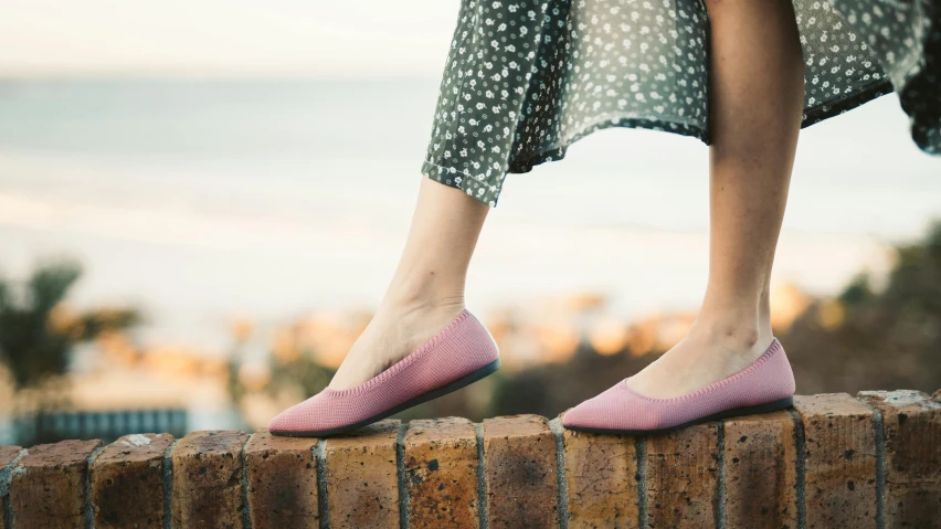 a woman's feet in shoes that are pink