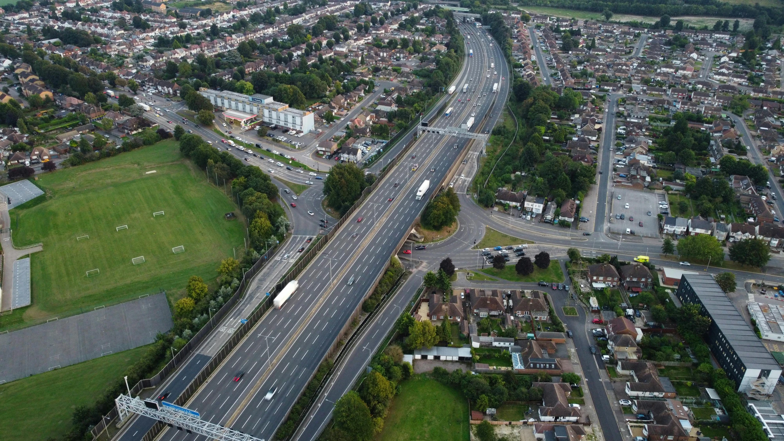 an aerial view of two lanes and a parking lot along the river