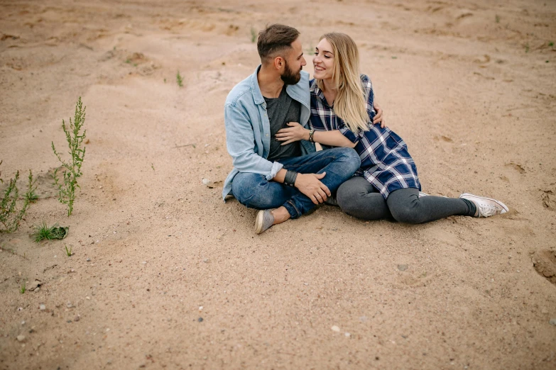 a couple is on a beach together smiling