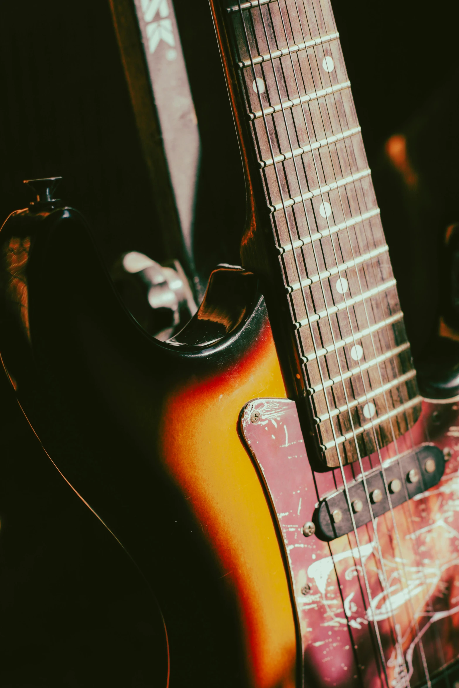 an electric guitar sitting next to a speaker