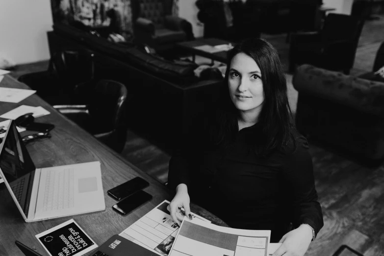 a black and white po of a woman holding some papers