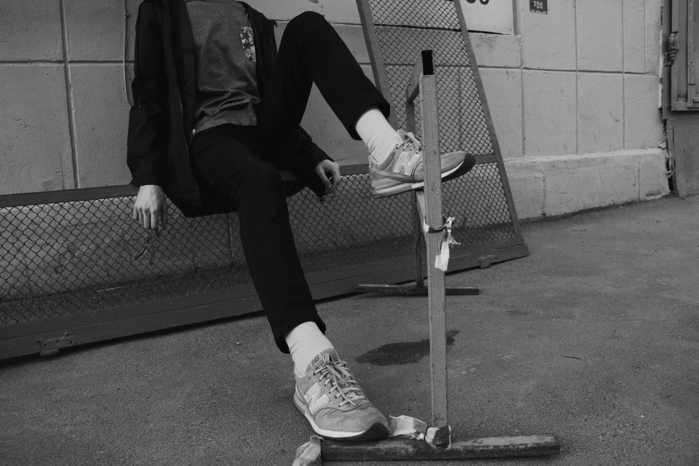 black and white pograph of  sitting on his skateboard