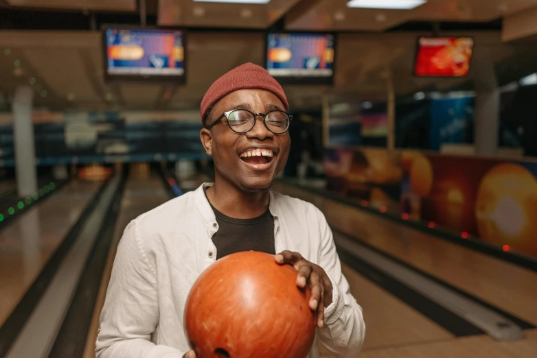 a man is bowling ball at an indoor bowling alley