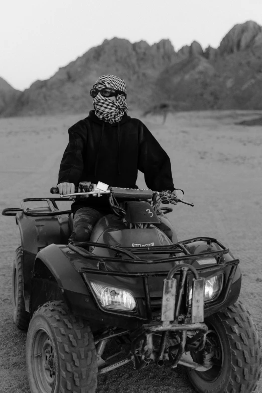 a person is riding an atv in the middle of the desert