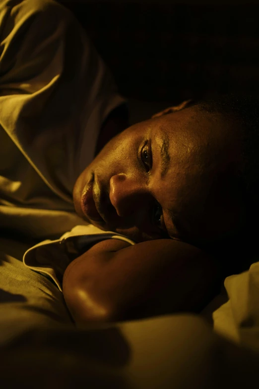 a man sleeping in bed looking over his shoulder