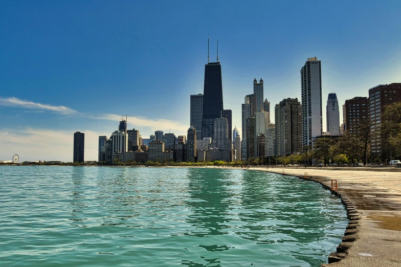 a city on a clear day near a calm lake