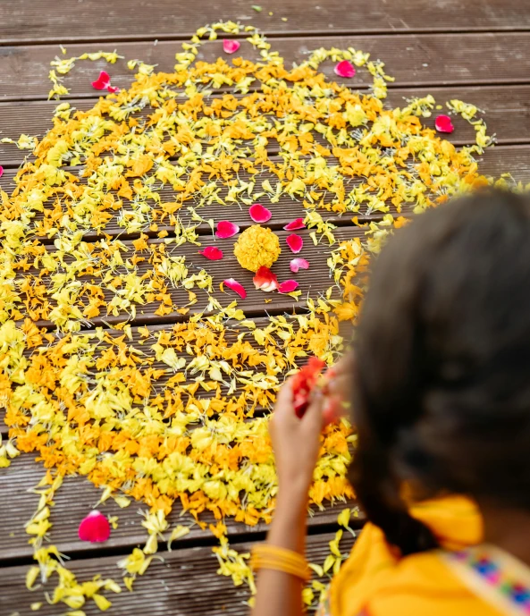 a child painting flowers on a walkway