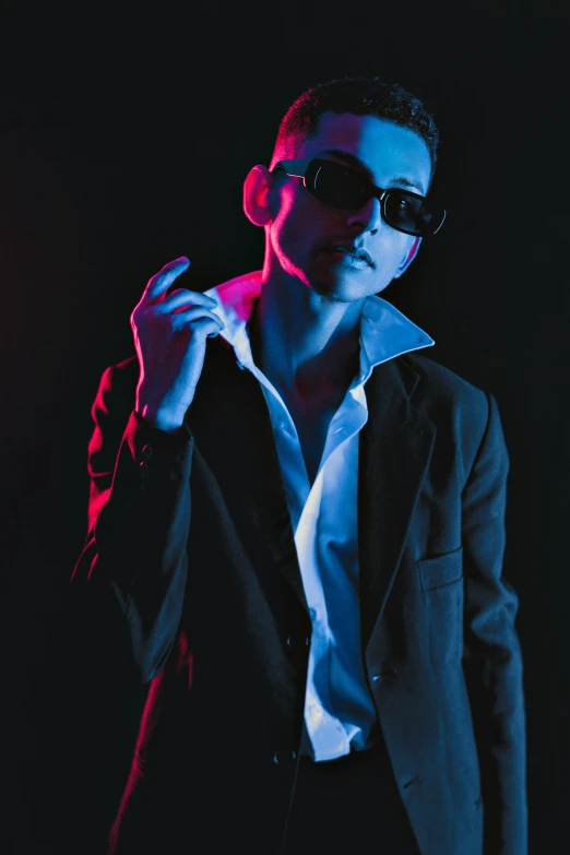 a man is wearing sunglasses and dark clothing