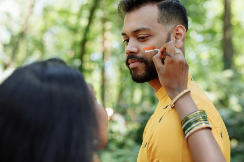 a man with a nose piercing using a cigarette