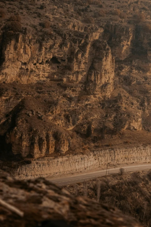 the view from above of rocky mountain area with road passing between them