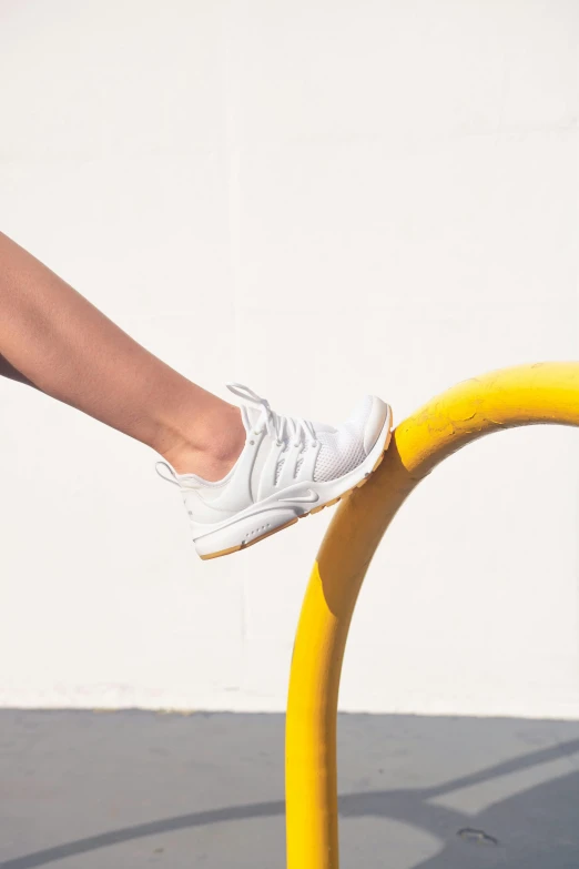 a person's feet standing on a metal pipe