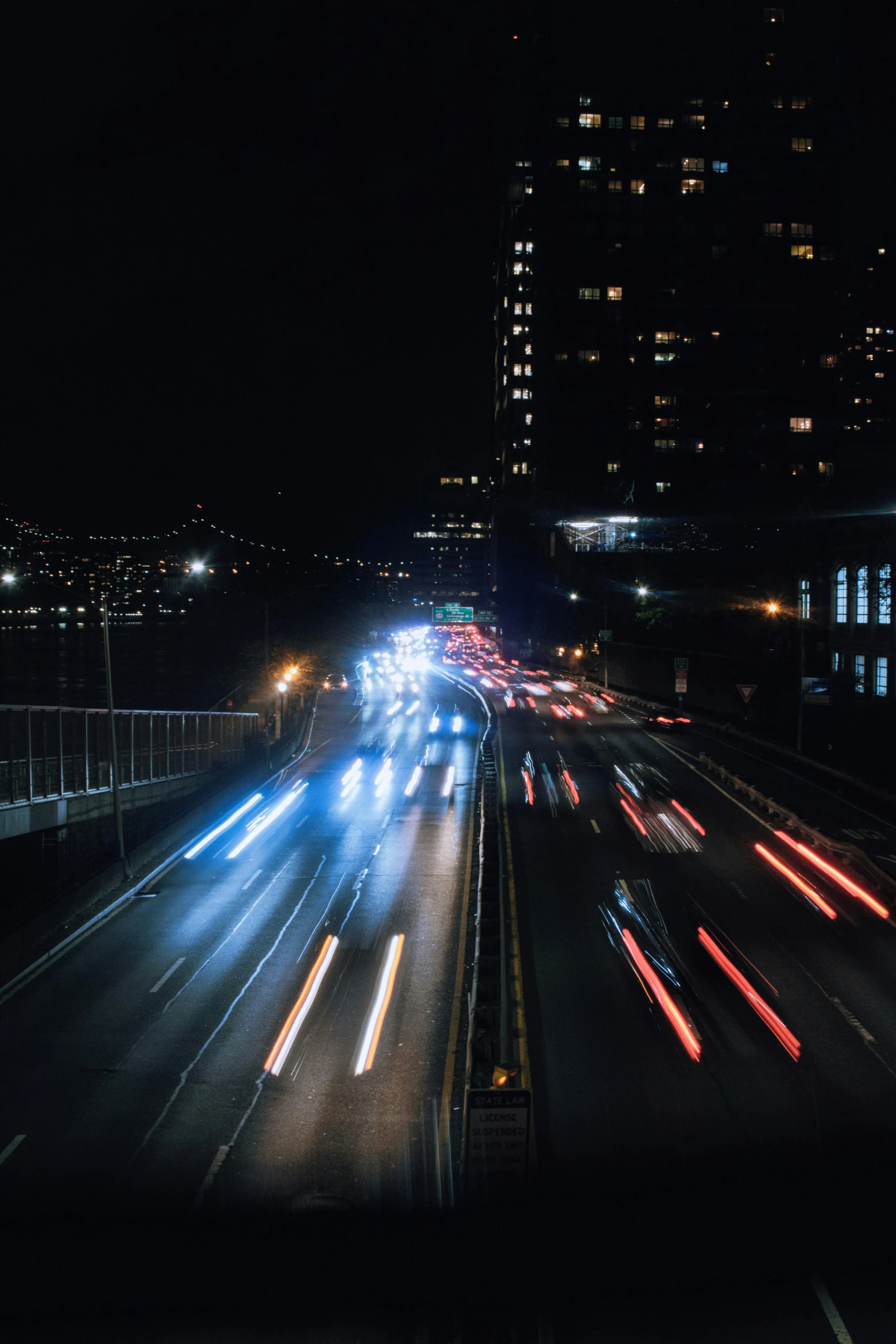 a night time scene of a highway with traffic