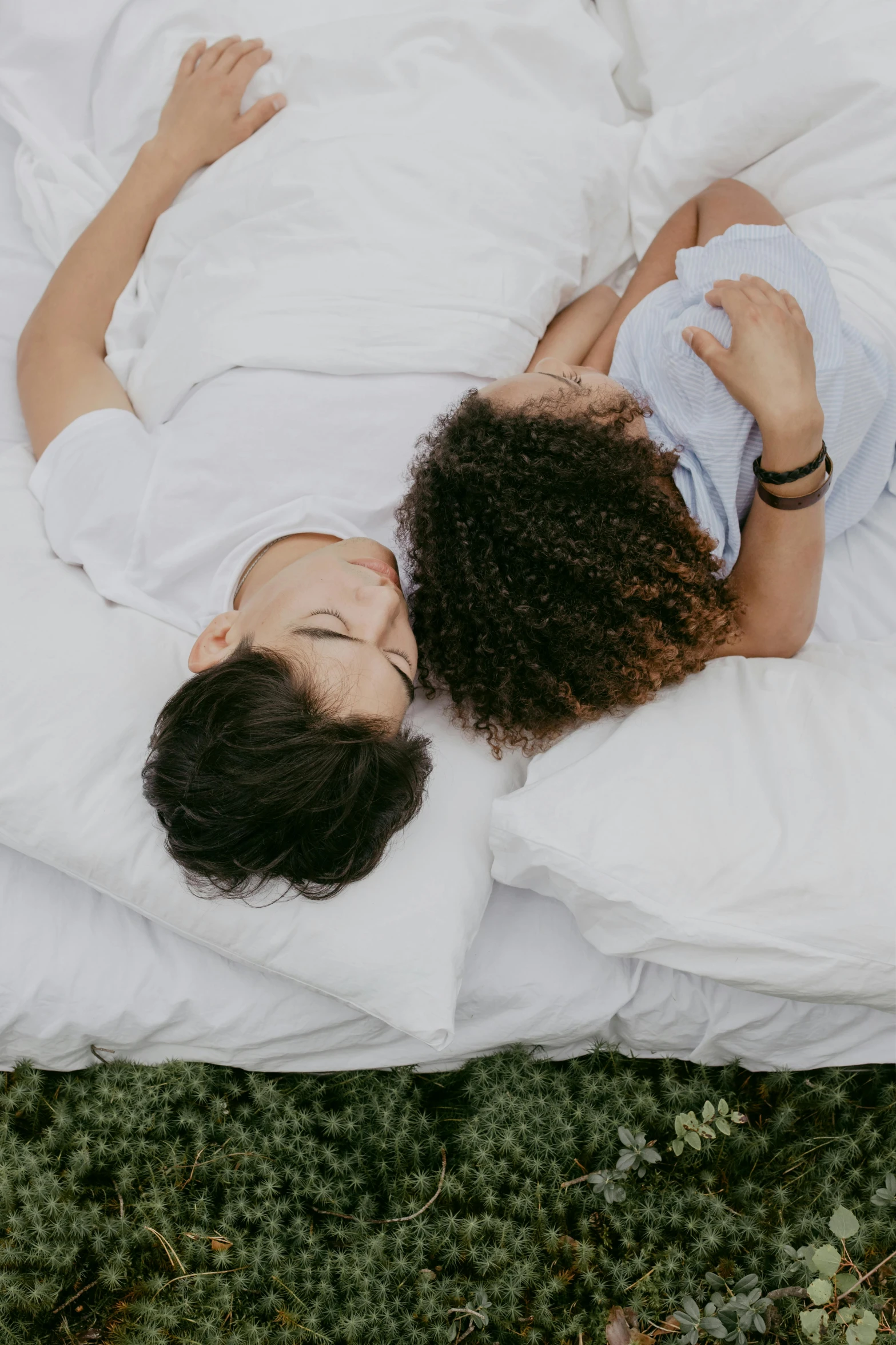 a woman is laying in the grass and sleeping