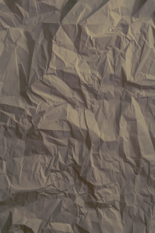 a piece of crumpled paper on a wooden table