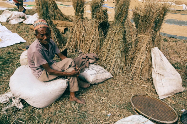 a man sitting on a pile of hay