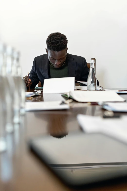 a man sitting at a desk using a laptop