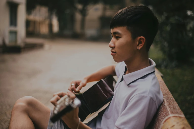 a person with a guitar on a street