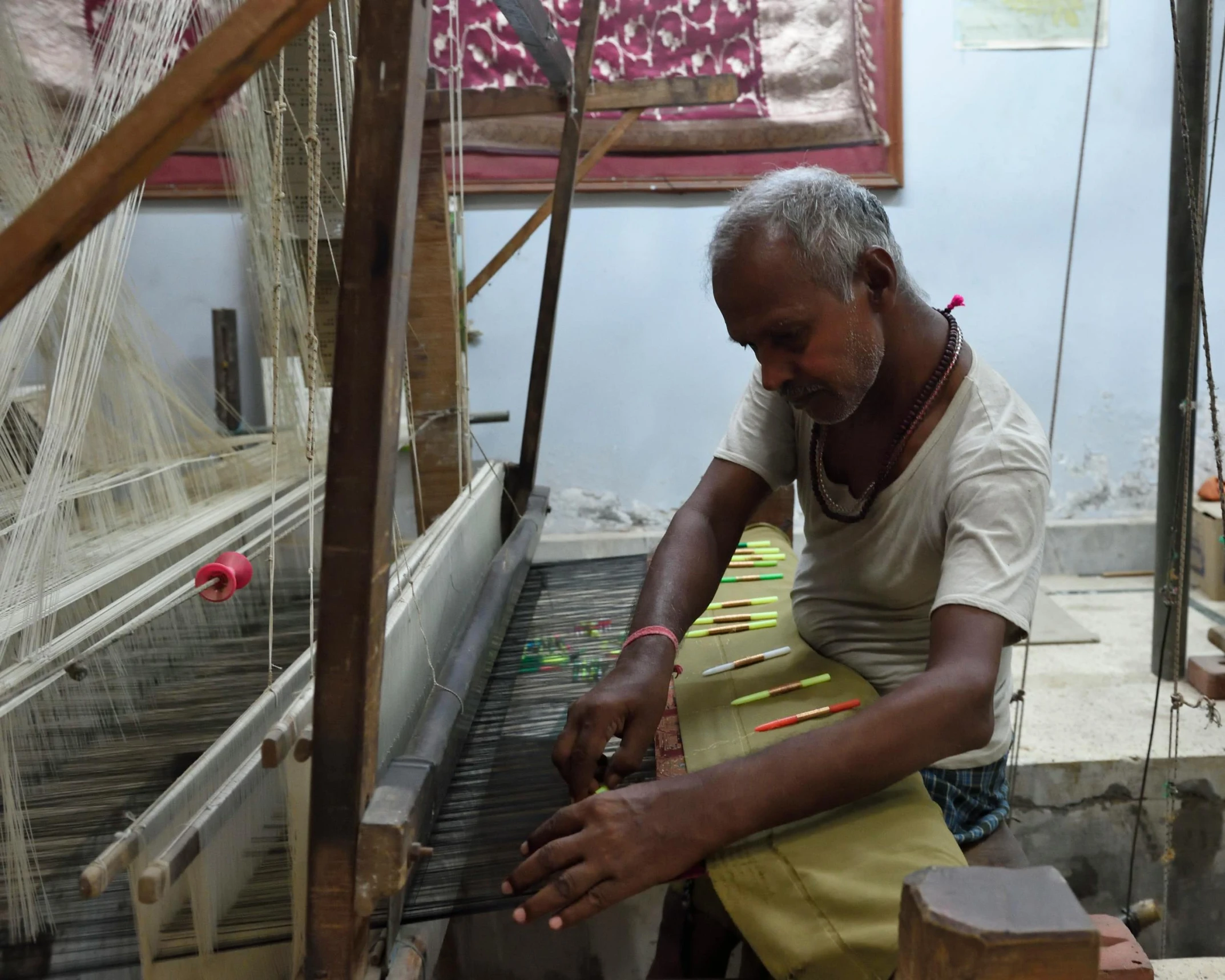 a person weaving fabric with a pair of scissors