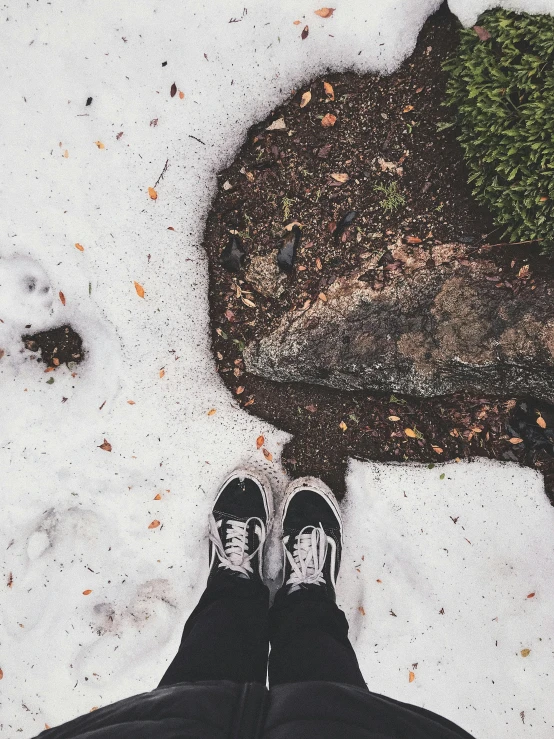 a person standing next to some snow