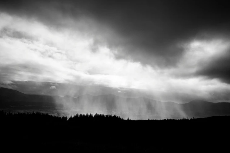 dark sky with sun rays coming through the clouds