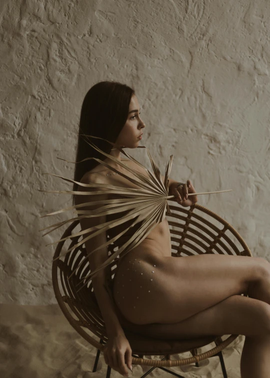  young woman with  on sitting in a bamboo chair