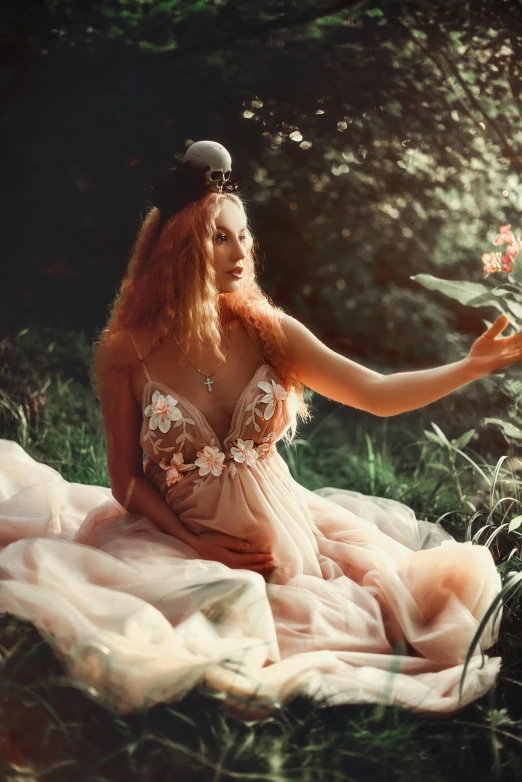 a woman with red hair sitting in the grass