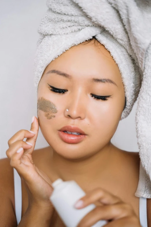 a woman using the top of her eye shadow