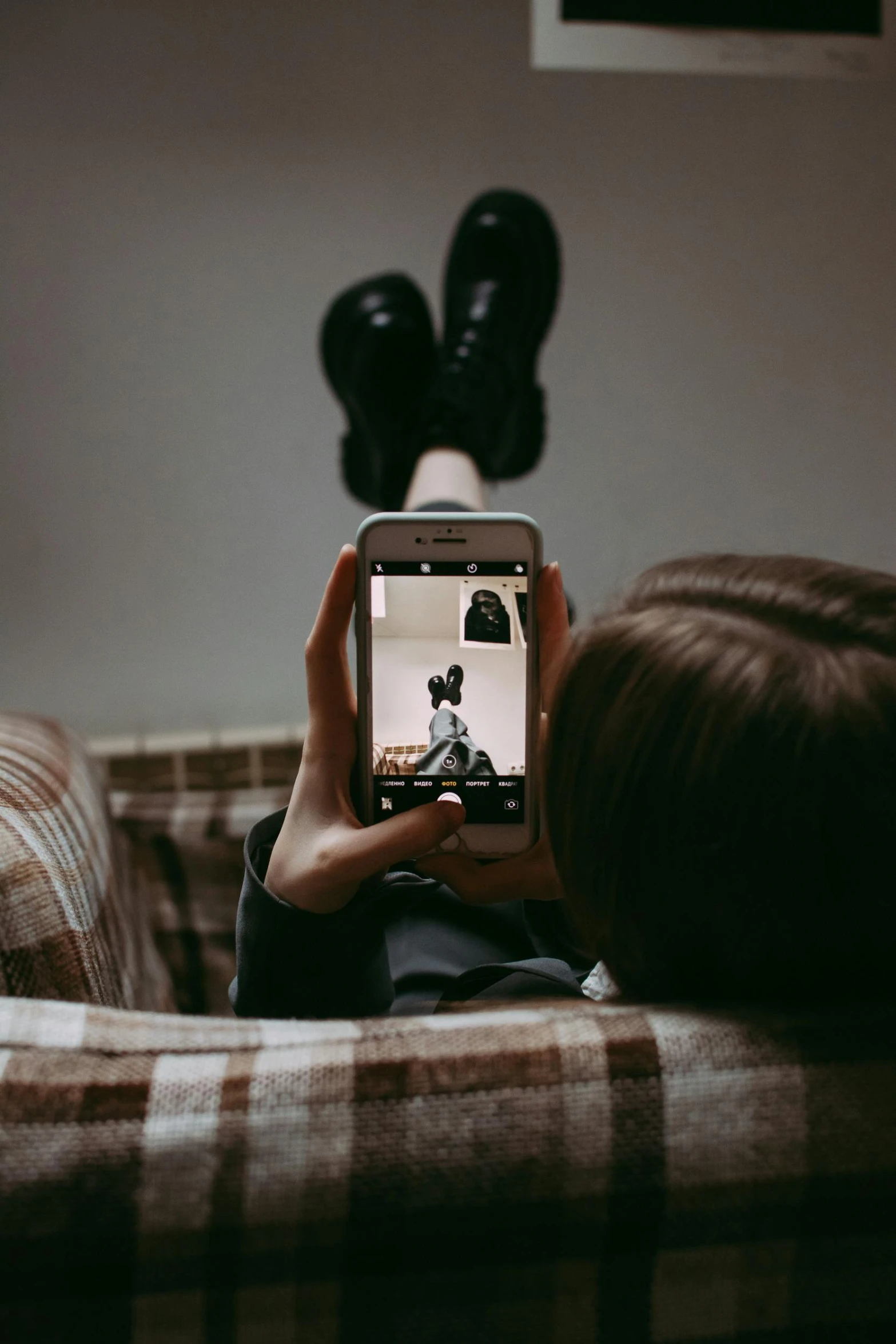 a person is sitting on a couch with a phone