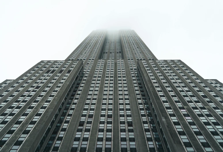 an upward view of the top of a building with a clock