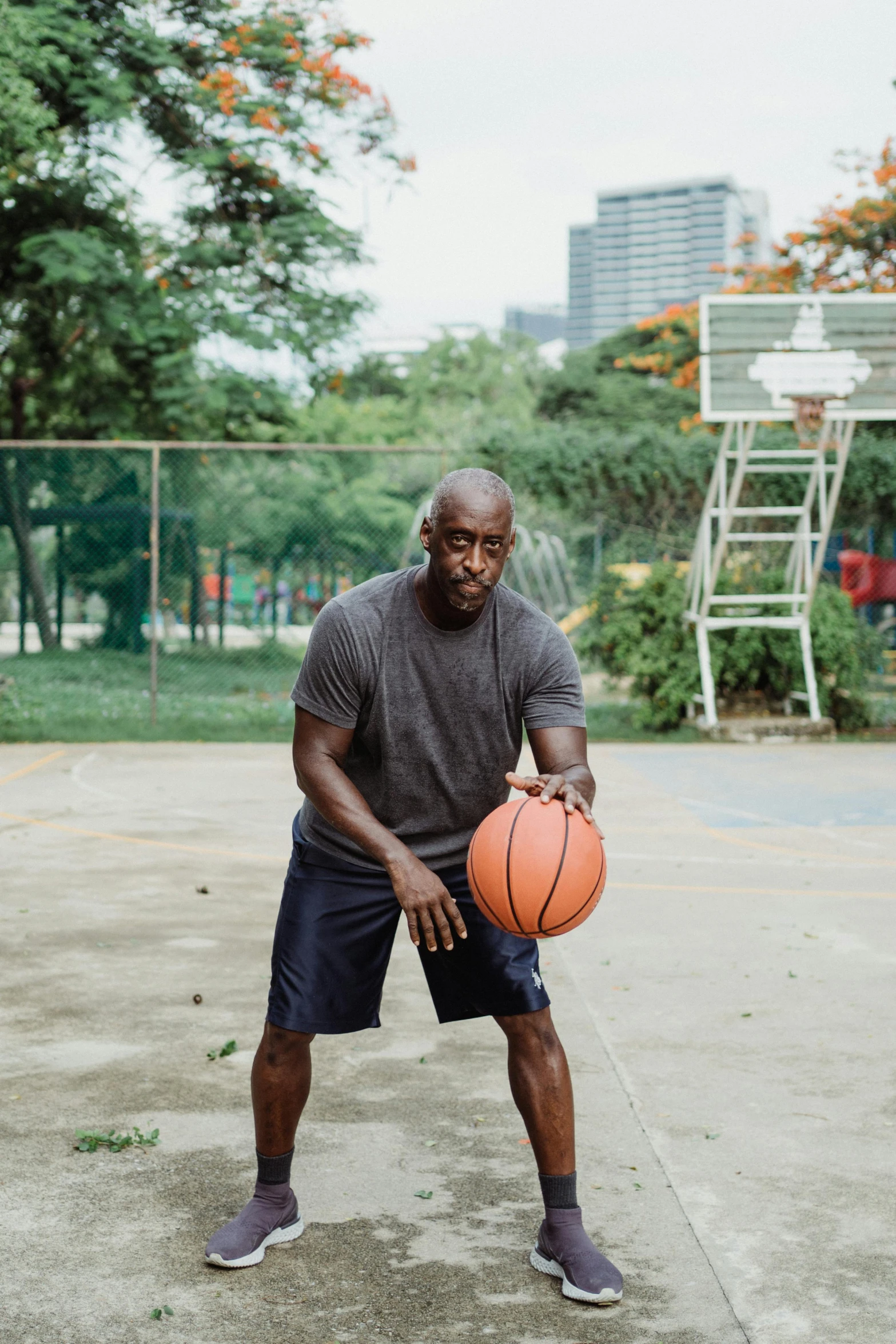 a man is holding a basketball and posing for a picture