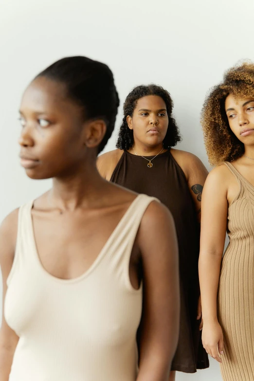 three women are standing together in a line