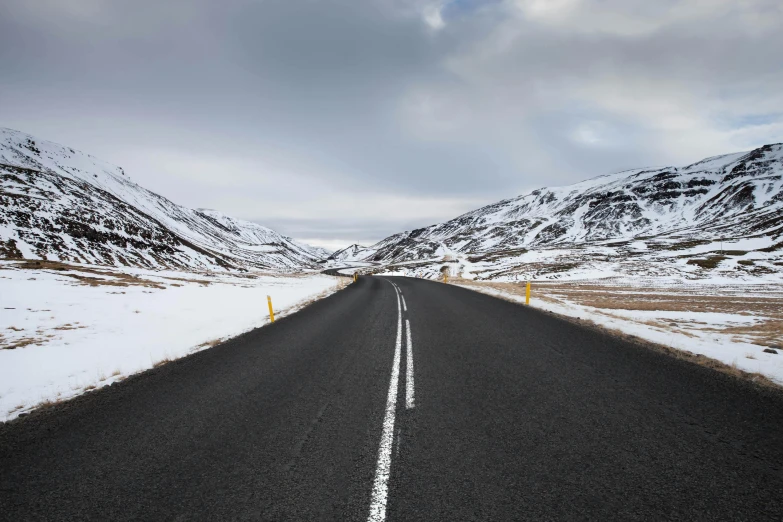 an empty road with a lot of snow on it