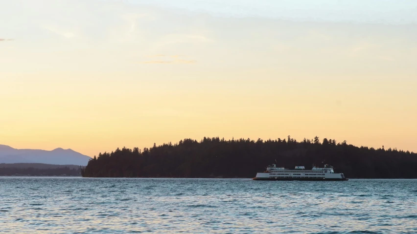 a large boat on a lake next to trees