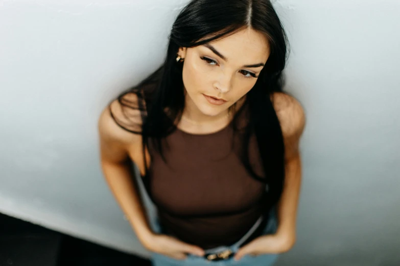 young woman with her hand in the pocket of a small blue backpack