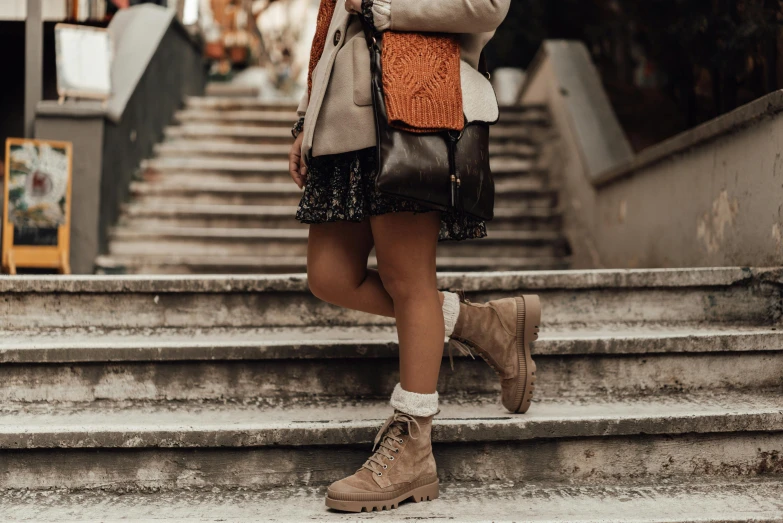 a girl is standing on some stairs and taking pictures with her phone