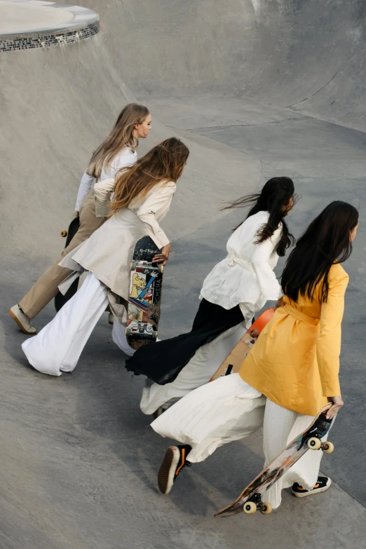 the three girls are walking along in a skateboard park