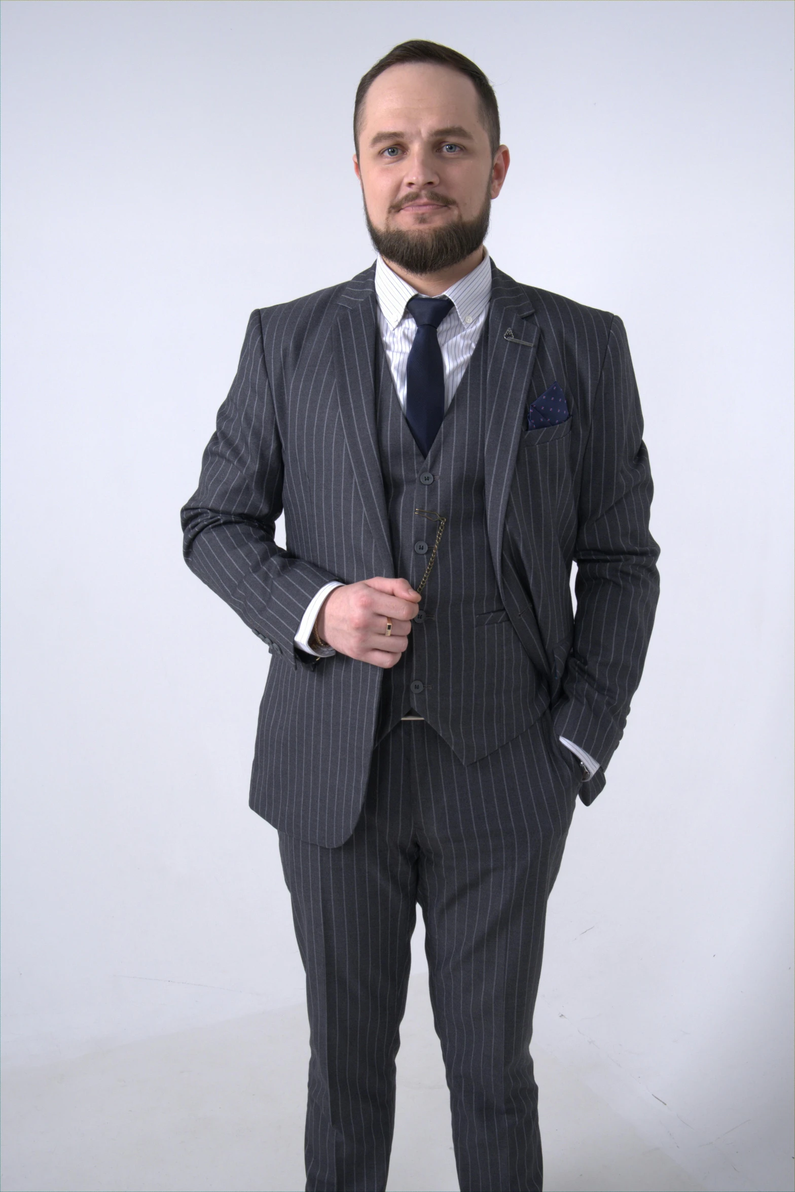 a man in a business suit, with beard