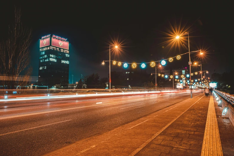 the cityscape with lights on and long street lamps