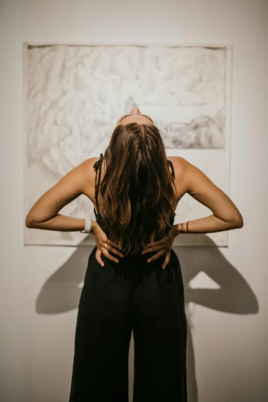 a woman is standing with her back to the camera