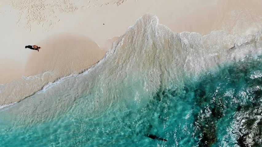 a man swimming in the water on top of waves