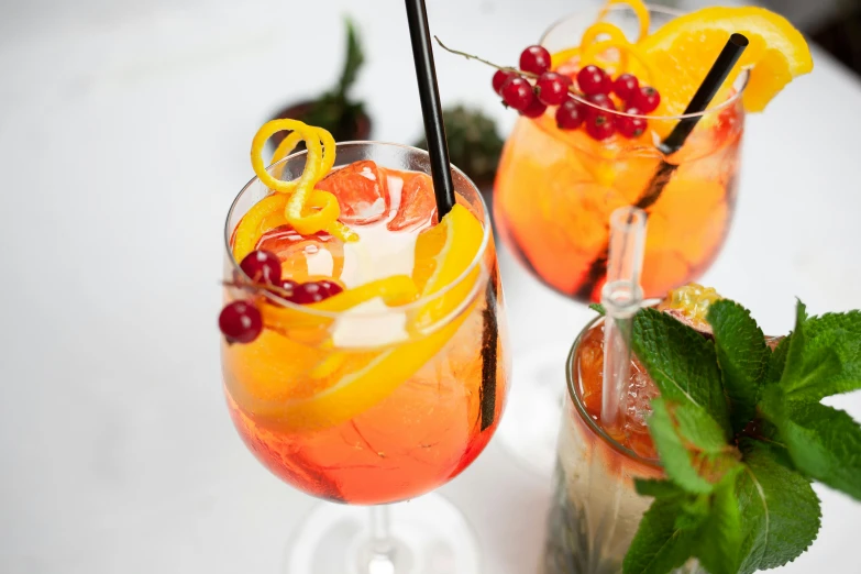 a couple glasses of fruit drink sit on a table