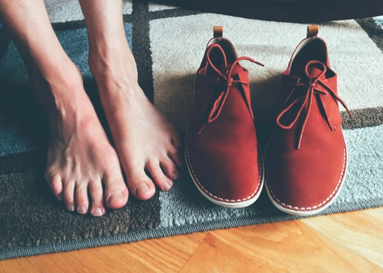 someone standing next to their feet on a rug