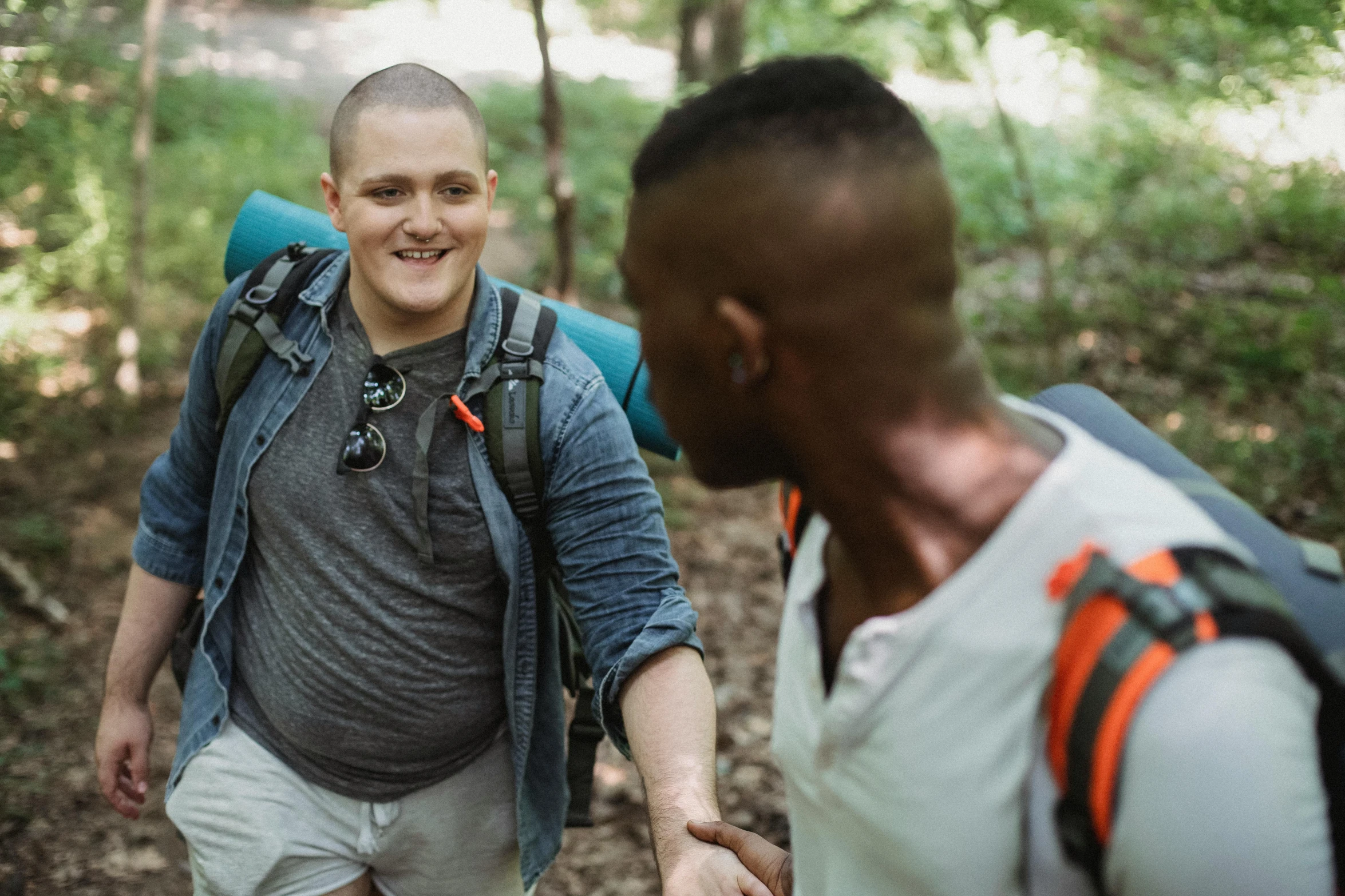 a man holding hands with a guy walking